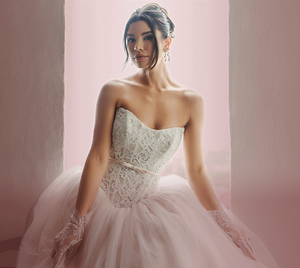 Model wearing a white Stella York Gown