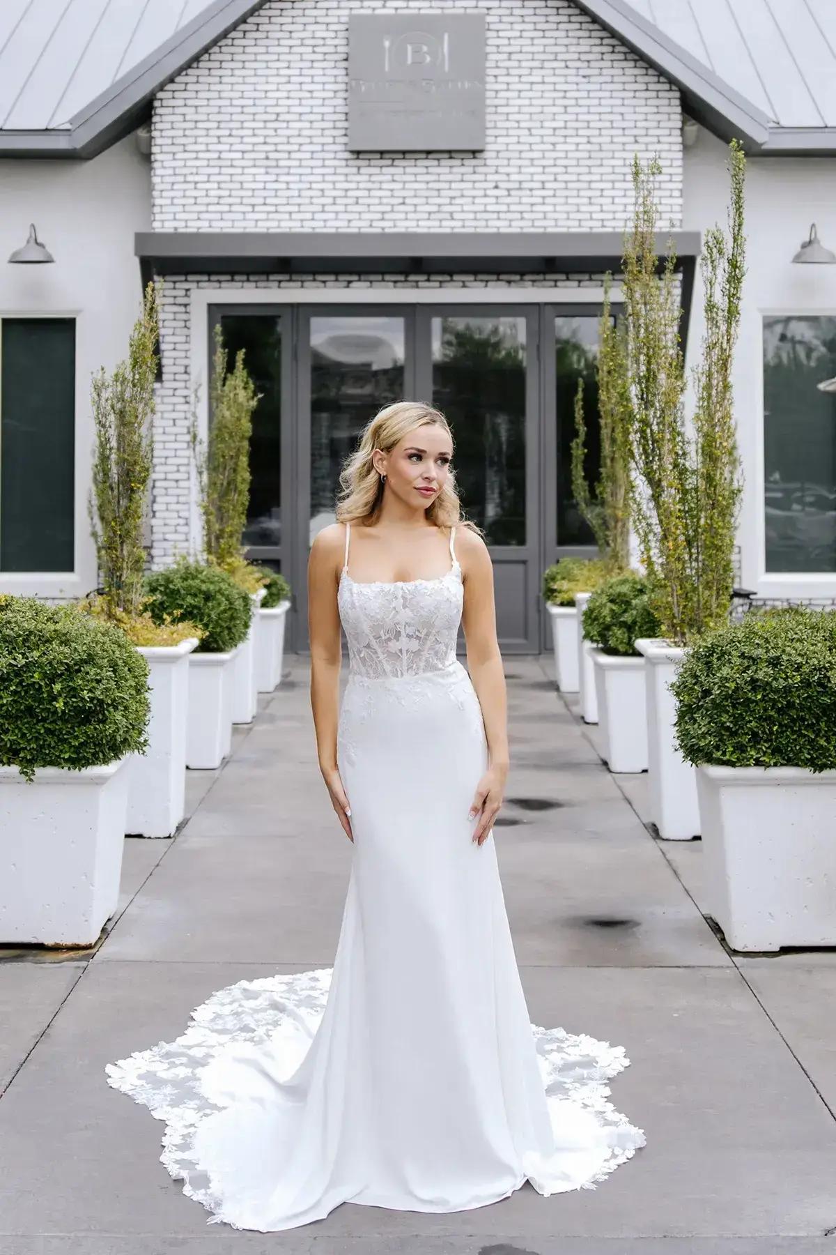 Model wearing a white Stella York Gown