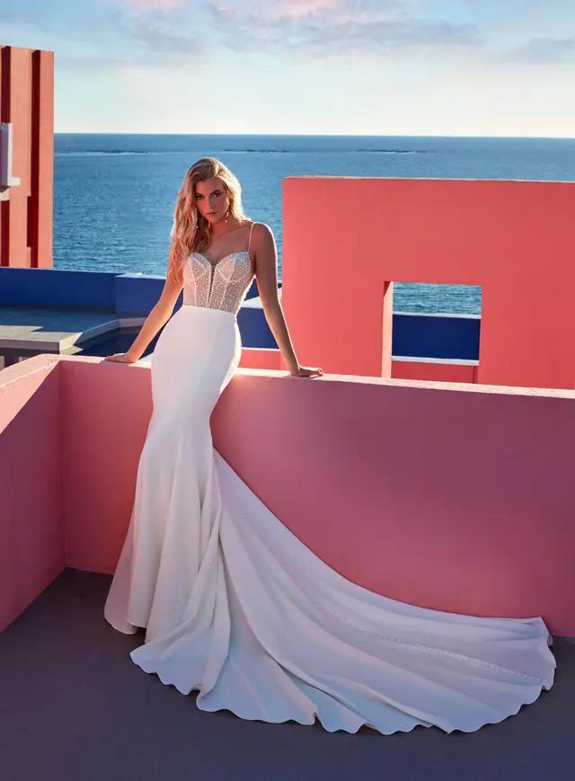 Model wearing a white Madison James Gown